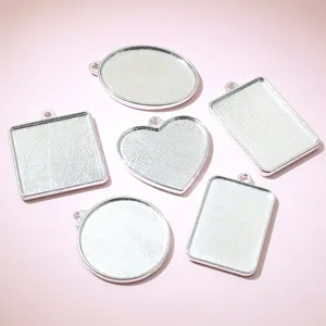 Set of six silver alloy DIY pendant trays in heart, oval and square shapes for jewelry making