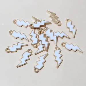 Macro detail of lightning bolt alloy pendants with white enamel for DIY jewelry making
