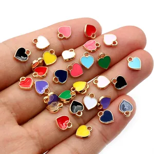 Mini multi-color 6x8mm heart pendants in palm for jewelry making and DIY crafts