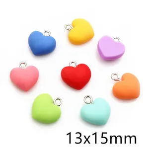 Macro detail of 13x15mm colorful resin heart pendants with silver metal rings