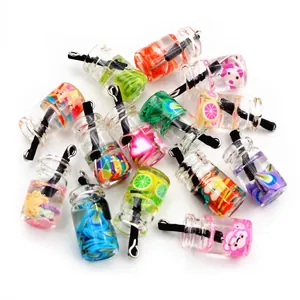 Macro shot of miniature bubble tea pendants with colorful liquid and fruit slices