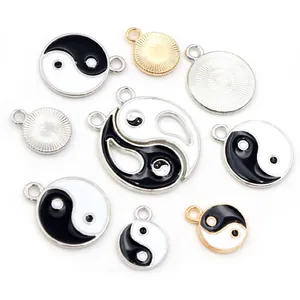 Macro detail of Yin Yang alloy pendants with gold and silver finishes for DIY jewelry crafts