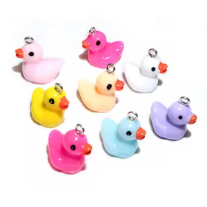 Close-up of colorful resin duck charms in multiple shades with metal loops for DIY jewelry