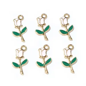 Macro detail of six white enamel rose charms with gold alloy edges for DIY jewelry