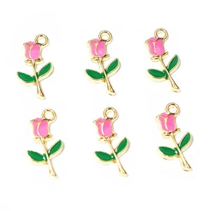 Macro detail of six pink rose flower alloy pendants with gold plating and enamel coating