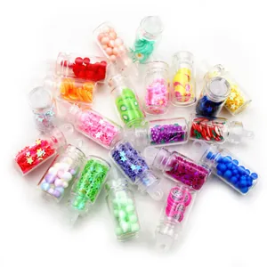 Close-up of miniature bubble tea bottles with colorful fruit slices and star sequins