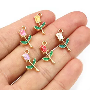 Set of five colorful rose alloy pendants in hand showing detailed oil-dripping craft