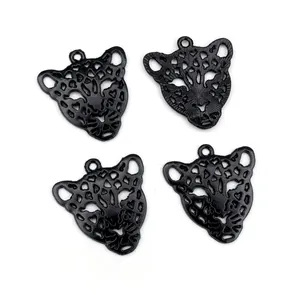 Set of four black alloy leopard head charms with intricate hollow design for DIY jewelry