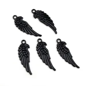 Set of five black alloy wing charms with detailed feather texture for DIY jewelry making