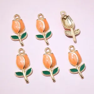 Detailed view of six orange tulip flower charms with golden alloy back and hanging loops