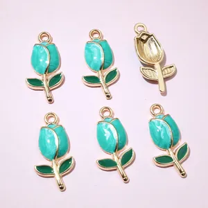Detailed macro view of tulip charms with green marble enamel and gold plating