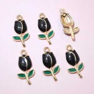 Detail of tulip pendant charms with black petals and gold edges for DIY jewelry making