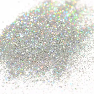 Macro shot of silver holographic nail glitter powder with sparkling rainbow reflection