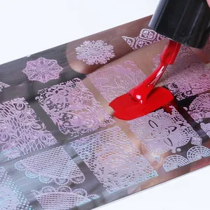 Macro shot of stainless steel nail stamping plate with lace and floral patterns