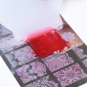 Nail art stamping plate with mandala patterns and white scraper for DIY manicure designs