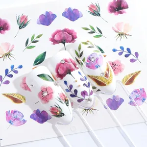 Nagel waterstickers met paarse bloemen en strass steentjes op witte puntnagels