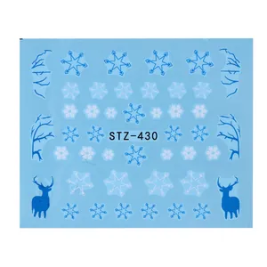 Close-up of Christmas snowflake nail stickers with reindeer and winter patterns