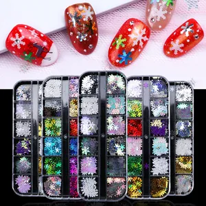 Detail view of colorful Christmas snowflake nail sequins in a 12-grid storage box