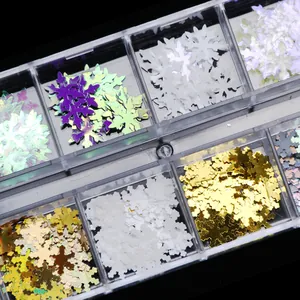 Macro shot of colorful laser snowflake nail art sequins in a multi-grid storage box