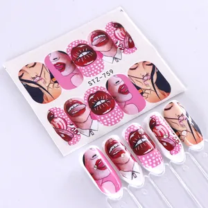 Detail of pop art nail water decals with sexy lips and female face designs on clear tips