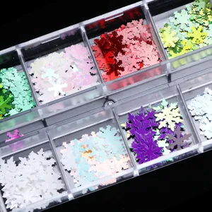 Detailed macro view of colorful snowflake nail glitter sequins in a 6-grid storage box
