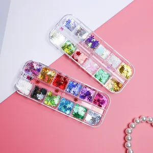 Close-up of 12-grid boxes with colorful snowflake nail glitters and pearl accents