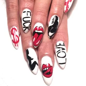 Stiletto press-on nails with white base and edgy street art designs featuring red lips