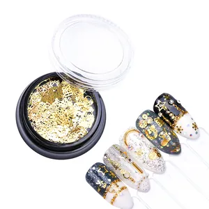 Detailed view of Christmas nail art glitter sequins and golden metal shapes on manicured nails