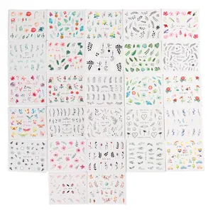 Flat lay of multiple nail art sticker sheets featuring butterflies and floral patterns