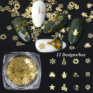 Macro shot of 12 golden Christmas nail art sequins including snowflakes and bells