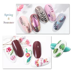 Tropical style nail art stickers featuring flamingos floral patterns and gold leaf designs