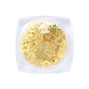 Golden Christmas nail art sequins kit with snowflake and tree shapes in a clear box