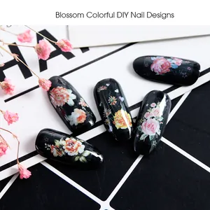 Macro shot of black glossy nail tips with vintage floral art and watercolor flower patterns