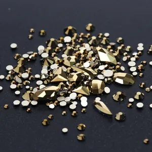 Macro shot of high-end champagne gold nail art rhinestones with geometric cuts