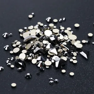 Macro view of assorted black and silver high-end flatback rhinestones for nail art designs