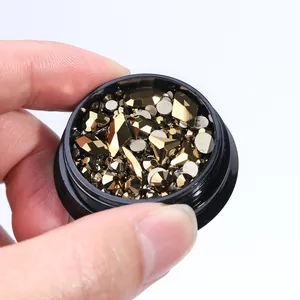 Golden flatback nail art rhinestones with geometric shapes in a black round jar