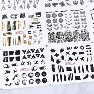 Close-up of black and white nail art stickers with geometric and animal leopard patterns