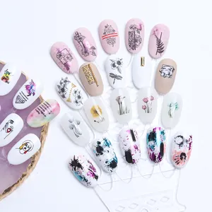 Detailed view of black and white line art nail stickers with abstract floral designs