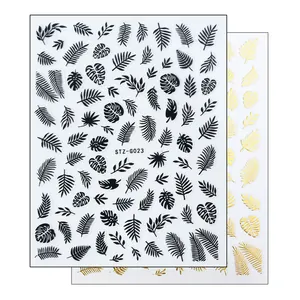 Detail of 3D nail stickers featuring tropical monstera leaves and gold palm leaf patterns