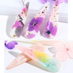 Detail of resin nail art charms with dried hydrangea petals and gold foil flakes