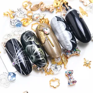 Detail of luxury nail art set with gold metal butterfly, pearls and floral nail tips