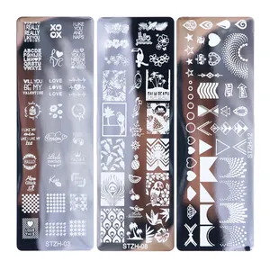 Macro view of stainless steel nail stamping plates featuring tropical and floral designs