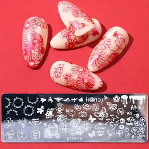 Macro detail of bee and flower pattern stamping plate with matching finished nail art tips