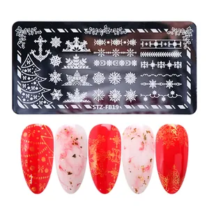 Macro detail of Christmas nail stamping plate with snowflake and tree patterns
