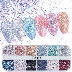 Detail of laser glitter nail art flakes set with shimmering samples on marble background