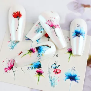 Macro detail of watercolor floral and butterfly nail stickers with rhinestones on nails
