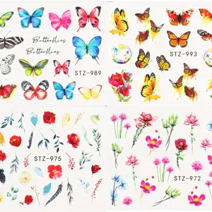 Macro detail of watercolor butterfly and floral water transfer nail art stickers