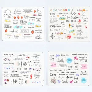 Detailed view of four nail art sticker sheets featuring floral, fruit and letter patterns
