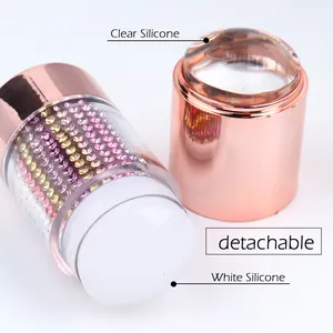 Macro view of detachable rose gold nail stamper with clear and white silicone heads