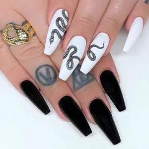 Detail of long coffin nails featuring black snake patterns and high-gloss finish